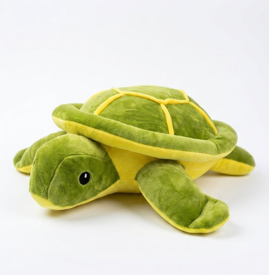 A green plush turtle toy with yellow accents, photographed on a clean white background. The brand name 'SoftSnuggle' is visible in the bottom left corner.